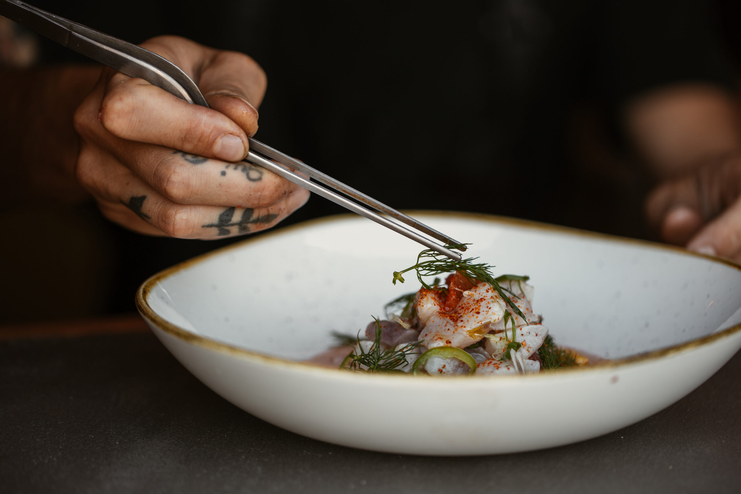 Food preparation garnishing at The Maine Ibiza